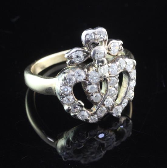 A late Victorian gold and diamond set entwined twin hearts ring, size L.